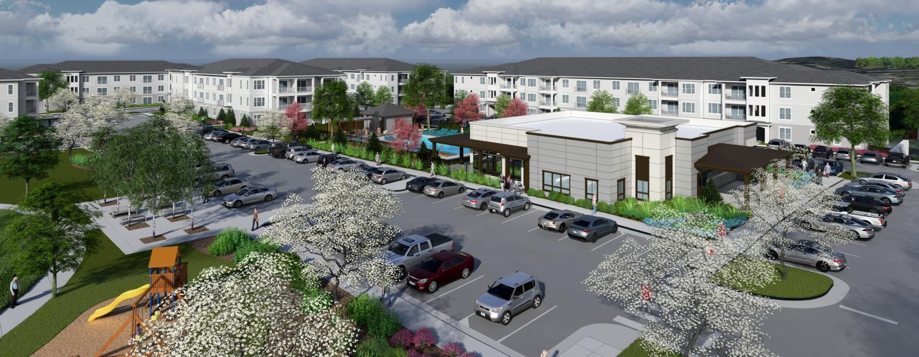 an aerial view of the apartment complex with cars in a parking lot