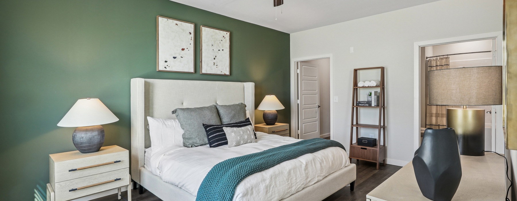 Queen sized bed with side tables, a dresser, ensuite bathroom and closet