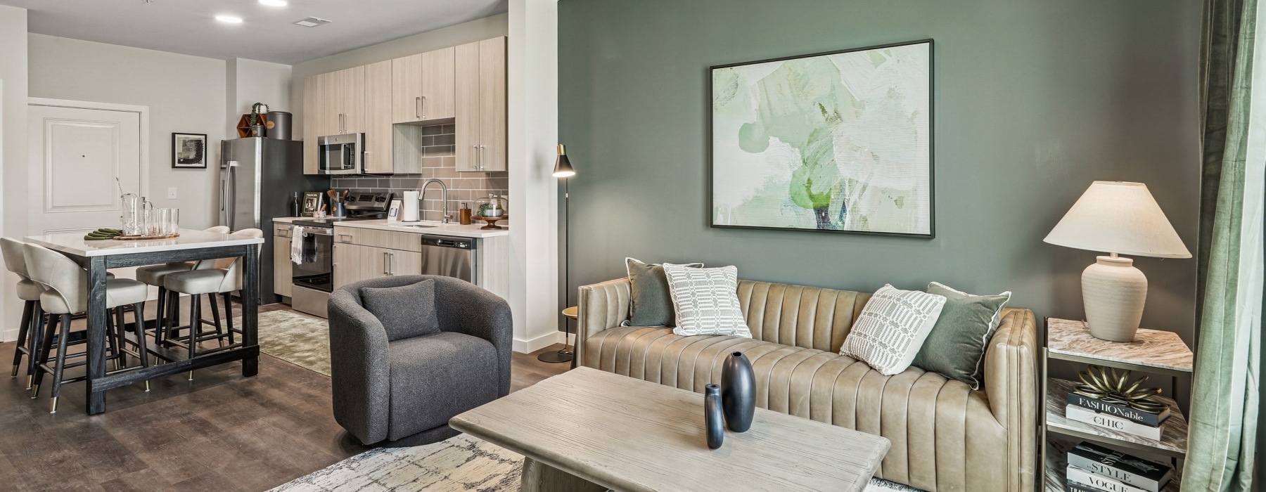 Open concept kitchen with eat in island, stainless steel appliances, to spacious living room