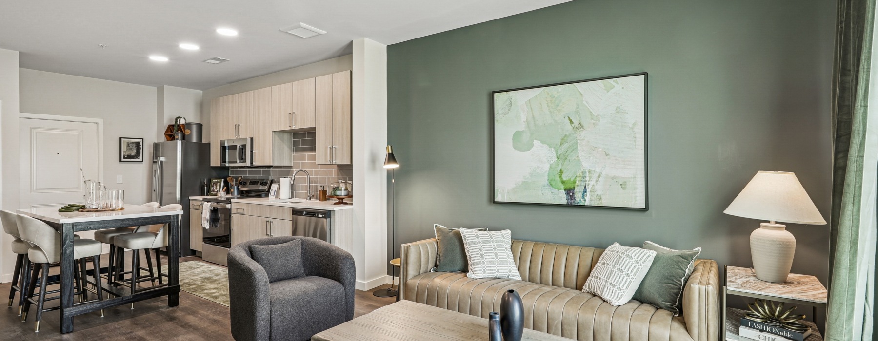 Open concept kitchen with eat in island, stainless steel appliances, to spacious living room